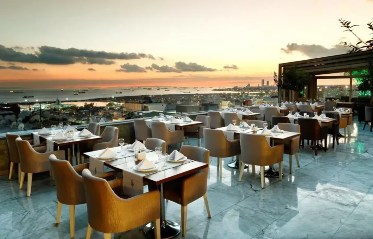 Rooftop restaurant tables with city and sea views